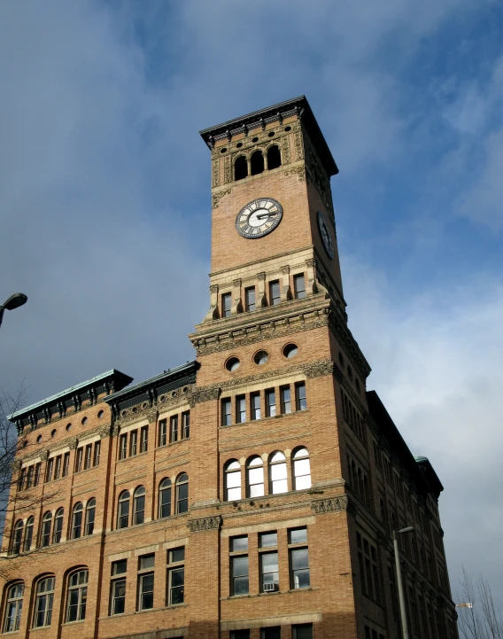 a tall clock tower sitting above a tall brick building