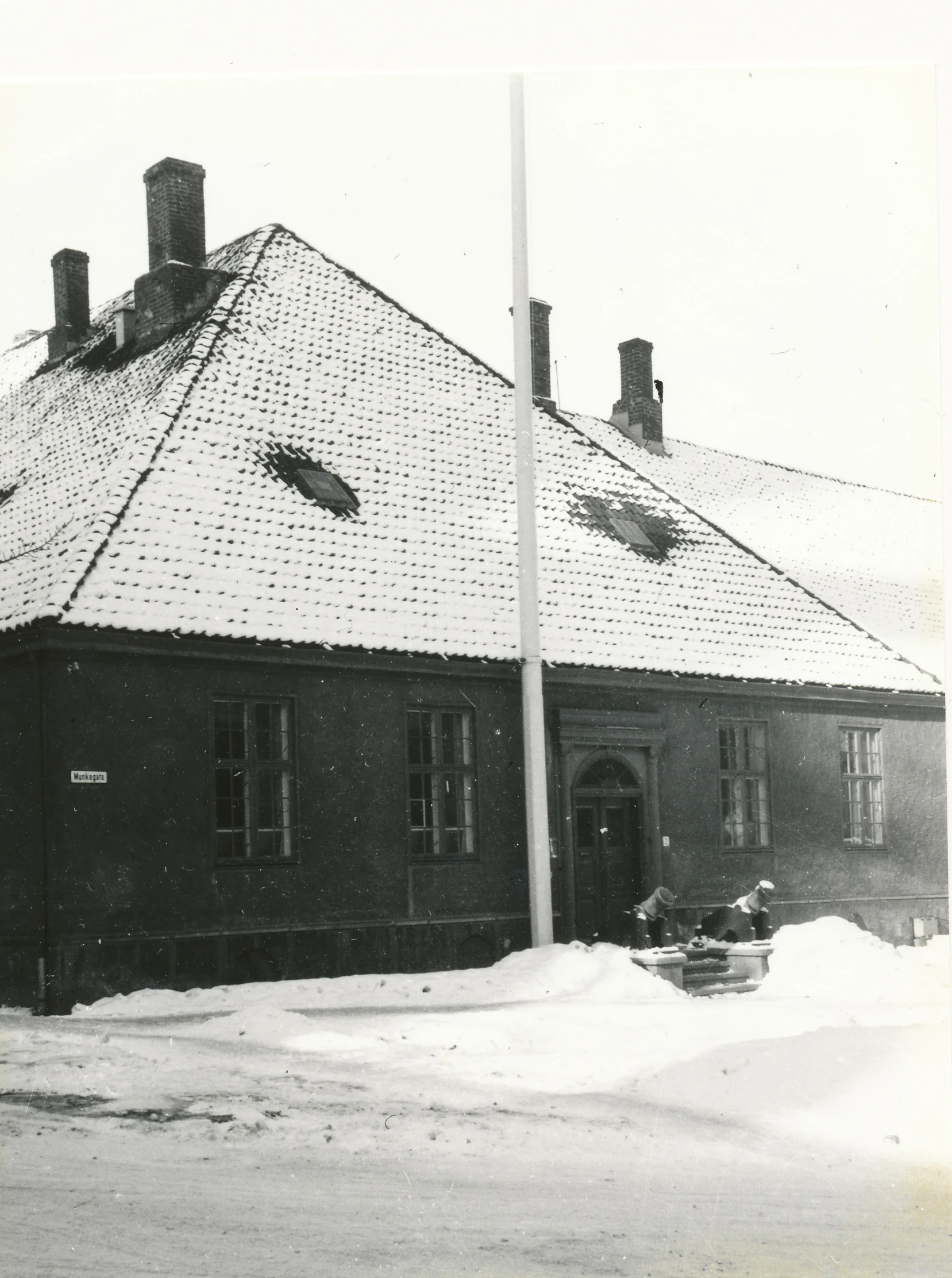 a black and white po of the outside of a building in the snow