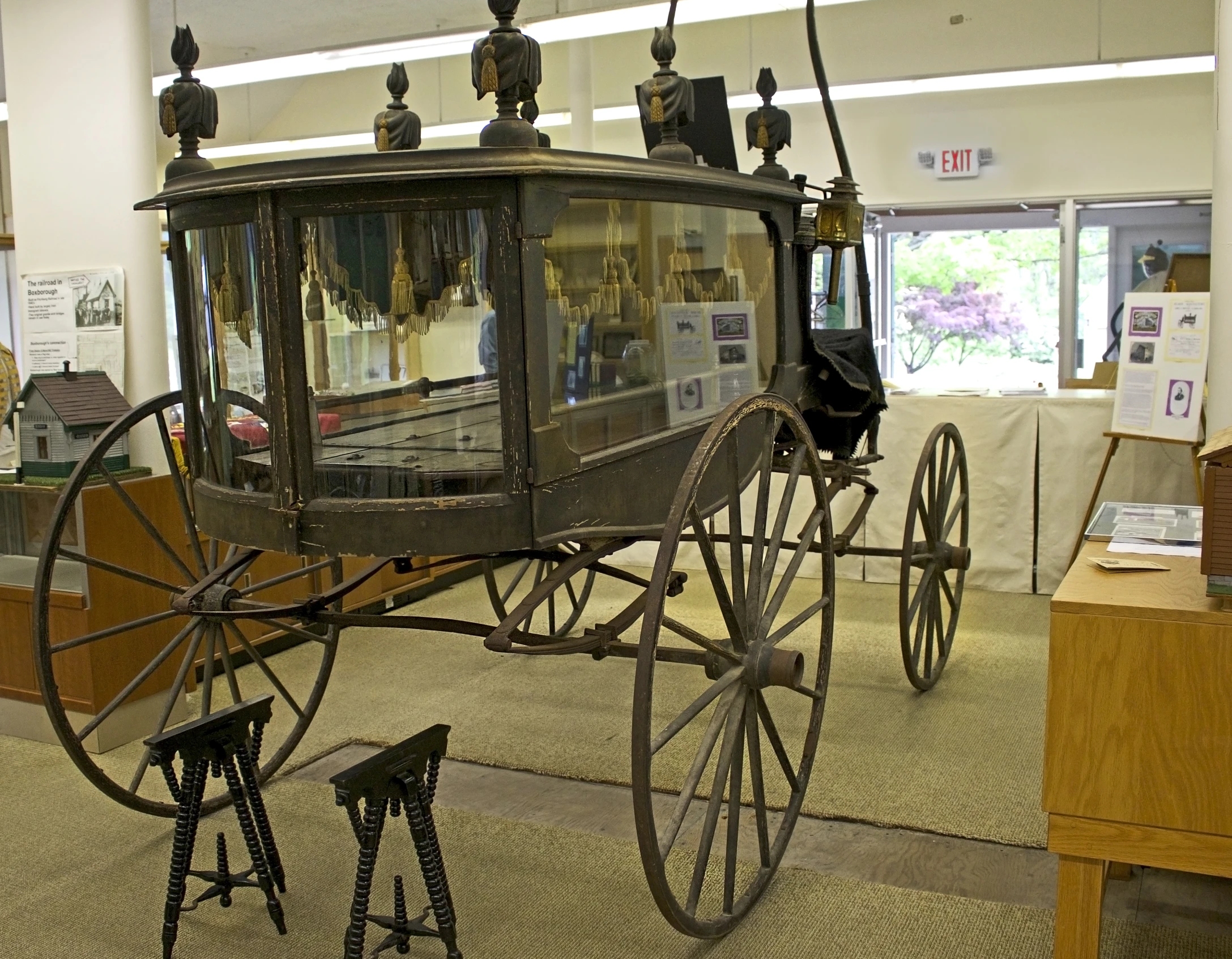 the antique carriage is in the museum and has metal parts