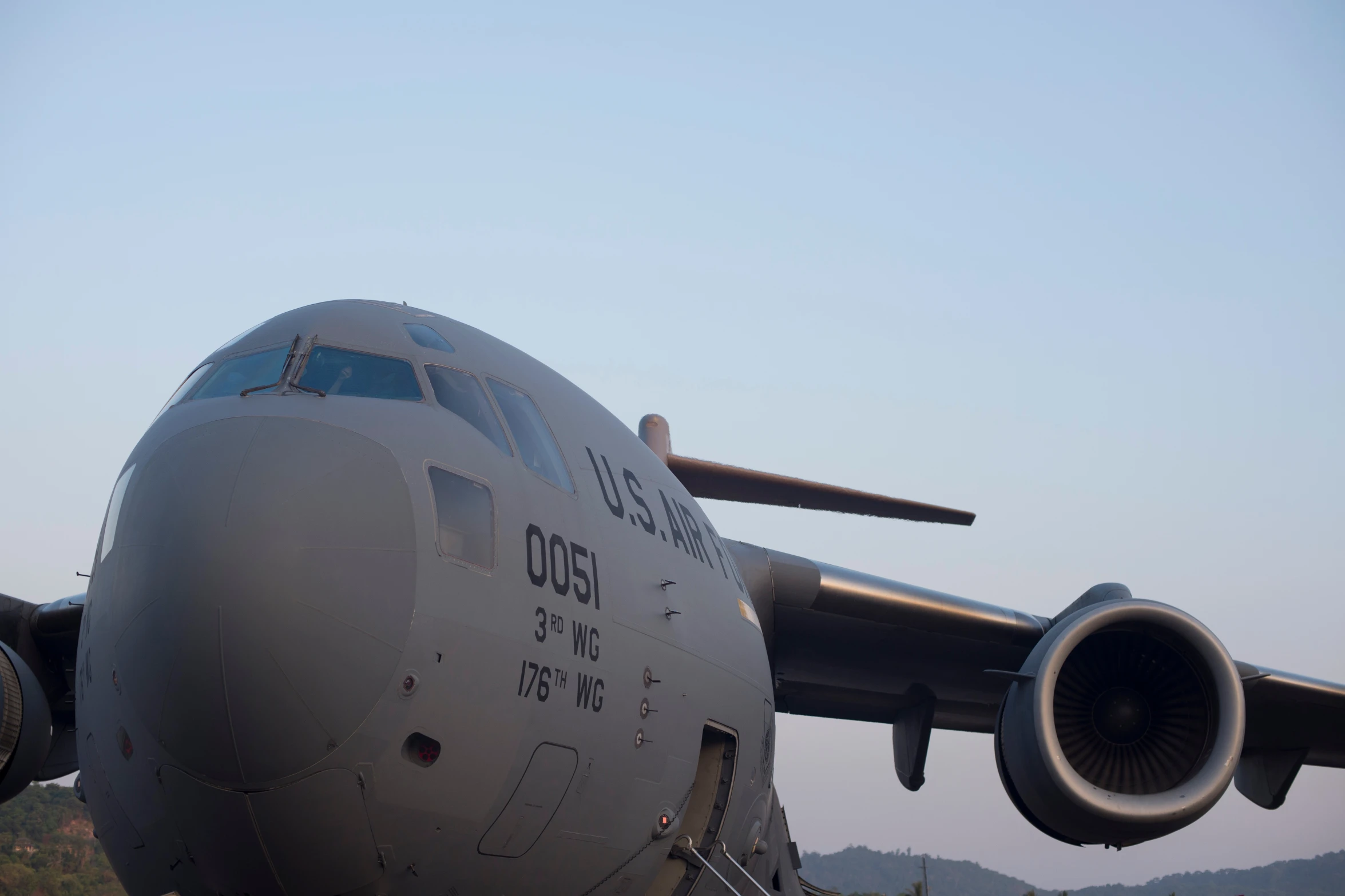 an airplane with the engine out and its propellor extended, taking off