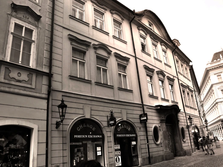 a building that has many windows with people walking around it