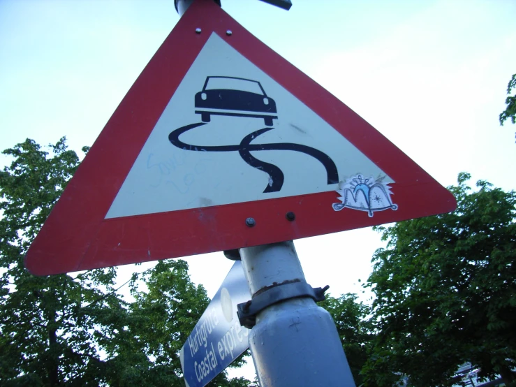 a street sign with a picture of a car on it