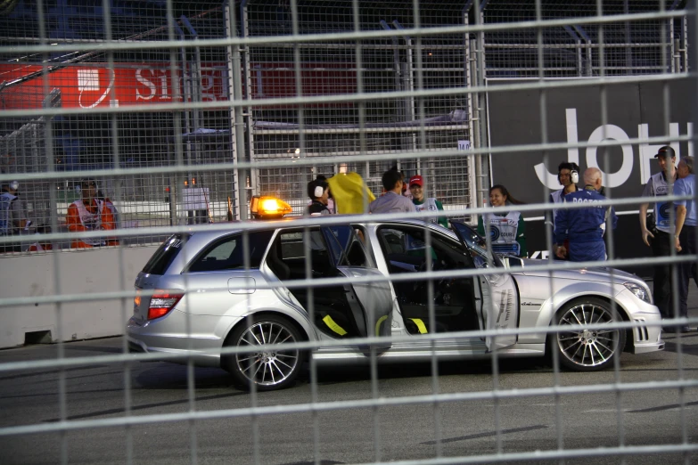 a silver car that is sitting in the street