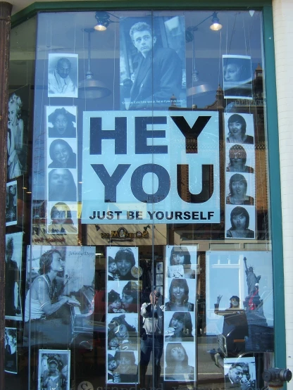 poster in front of store front window advertising the return of the black movie they you