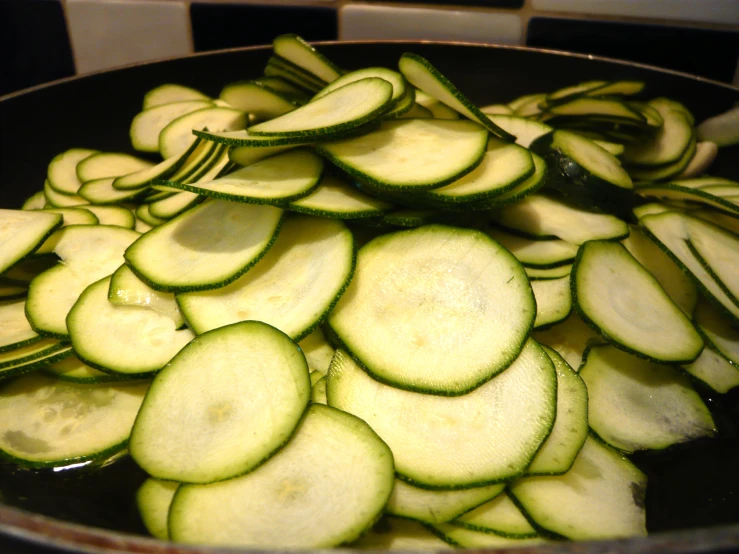 the table is filled with sliced up vegetables