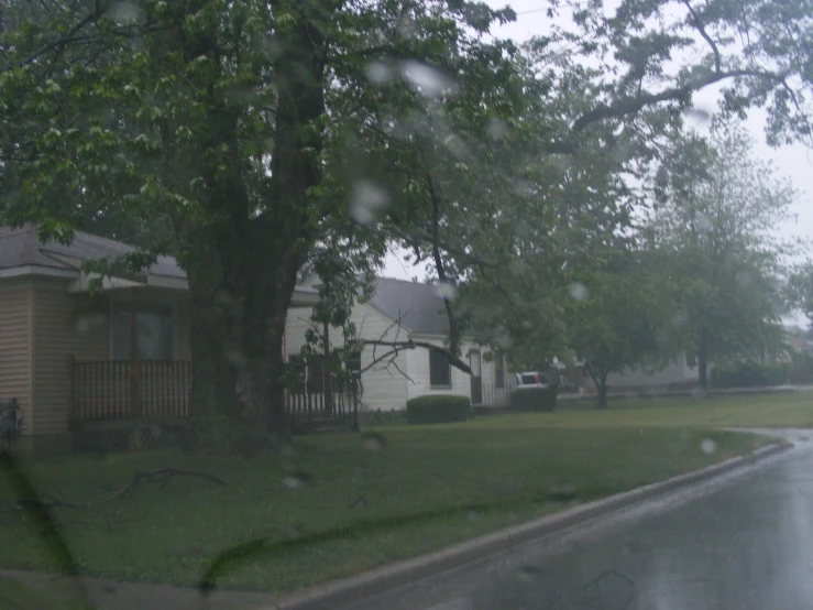 a rainy day in the country with houses and trees