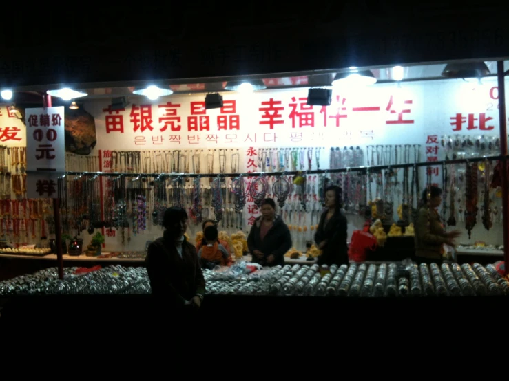 people look at items in front of an asian shop
