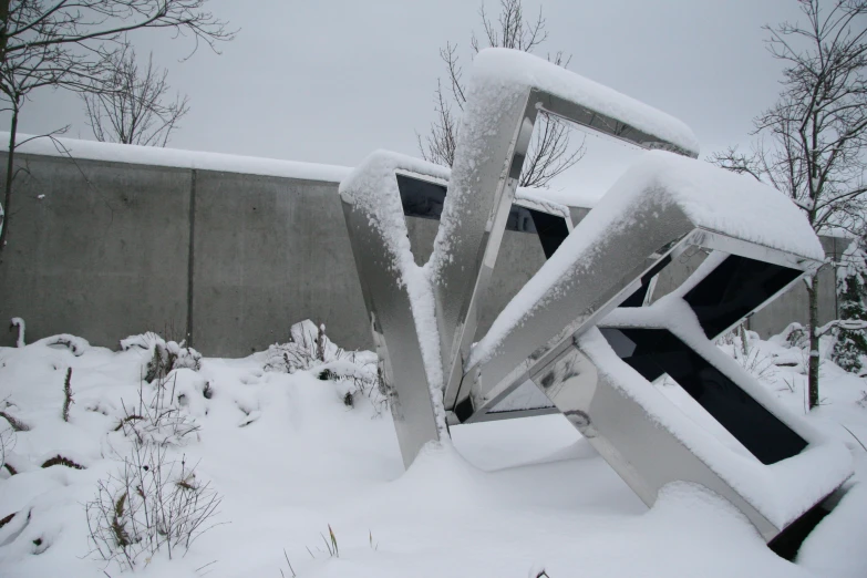 two large wooden pieces of ice sit in the middle of some snow