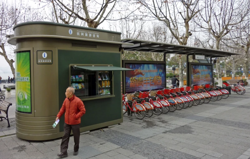 a number of bikes parked next to a small kiosk