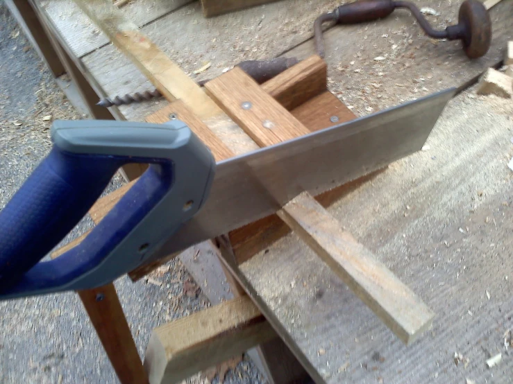 a large wood working knife resting on some planks
