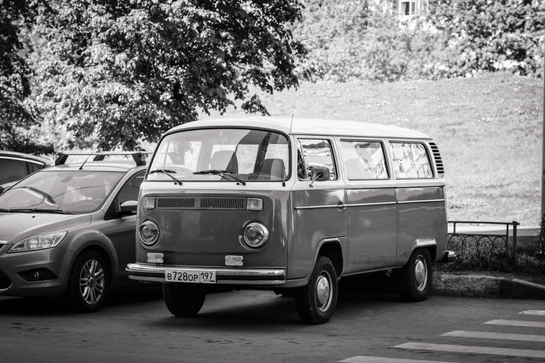 an old volkswagen van parked in the middle of a parking lot
