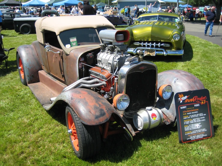 a vintage car with an odd engine on display