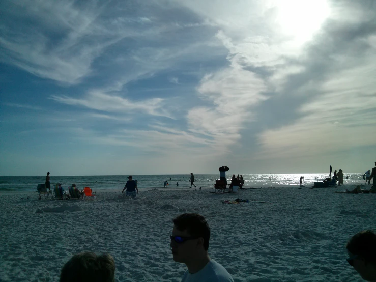 a person standing on top of a sandy beach near the ocean