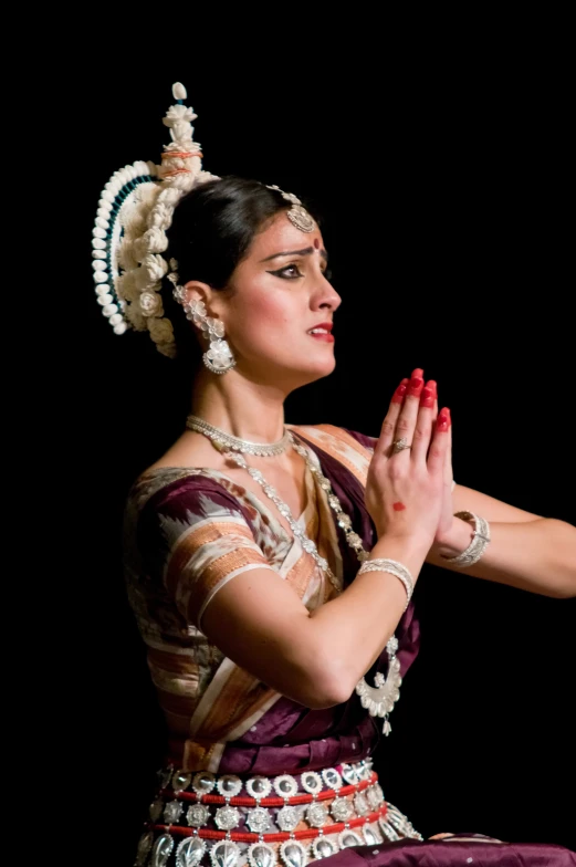 a woman wearing traditional garban performing a religious dance