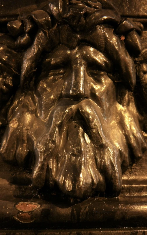 a close - up of the head of a golden statue