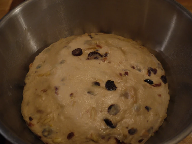 an uncooked bread is in a silver bowl