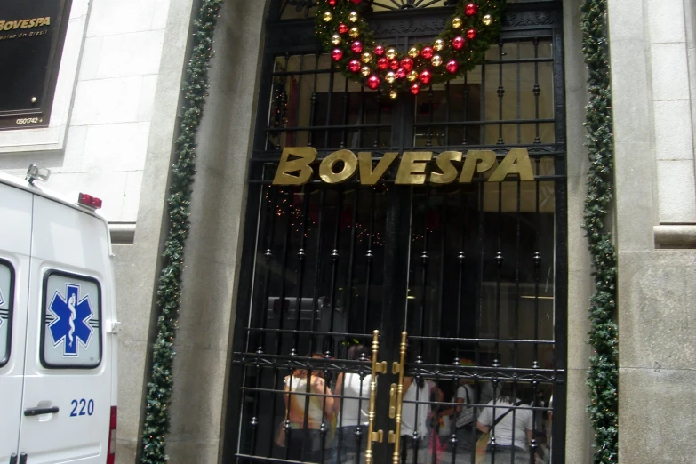 the door of a large building decorated with christmas wreaths and garland