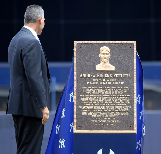 an award recipient standing next to a memorial plaque