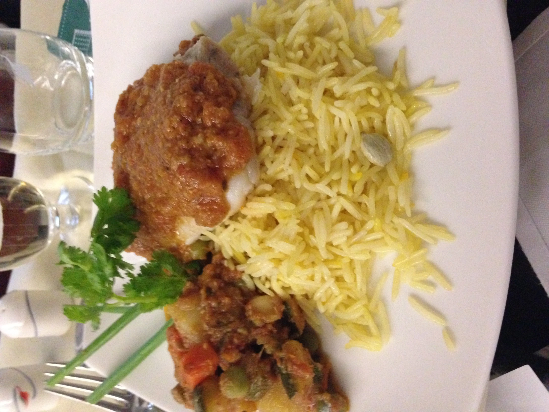 a plate topped with rice and chicken next to a salad