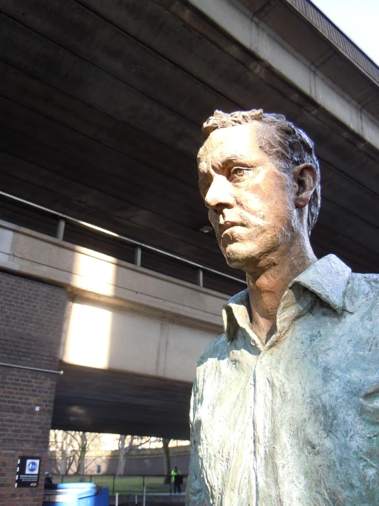 a close up of a statue of a man in front of a street