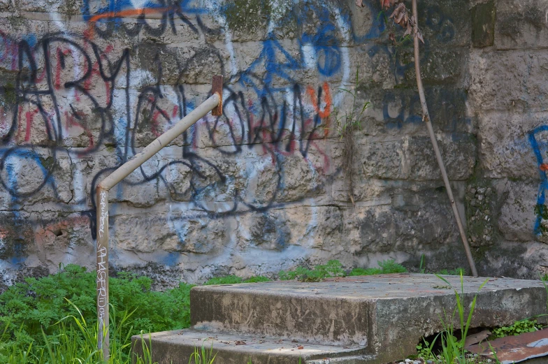 an old staircase is painted with graffiti and moss