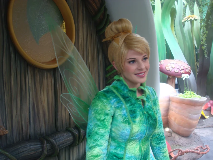 the image shows a woman dressed as tinkerbell