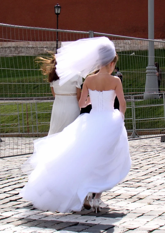 two girls dressed up and walking down the road