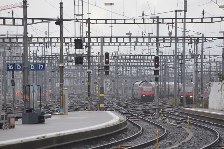 a train station with multiple tracks with various trains on them