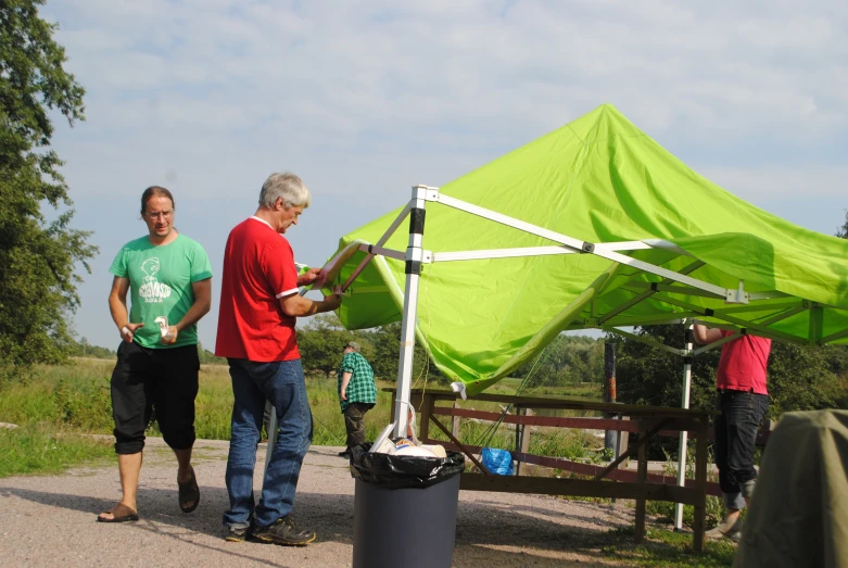 a couple of people that are by a green umbrella