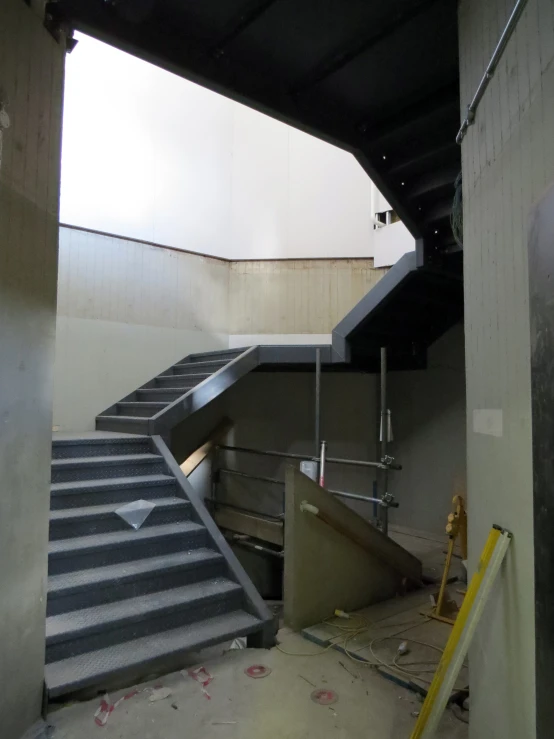 the stairs are going down the ramp towards the next room