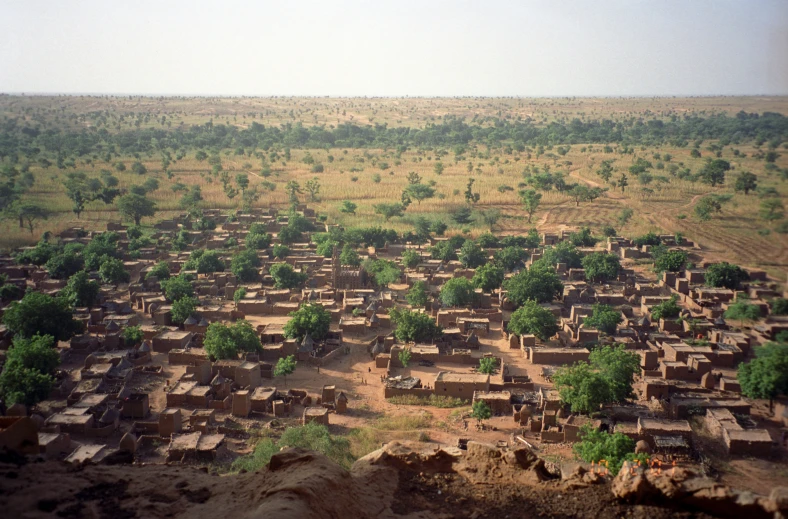 an open field with a bunch of houses in it