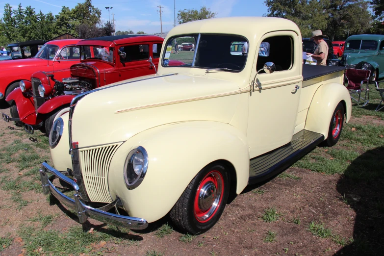 the classic trucks are parked near the other antique cars