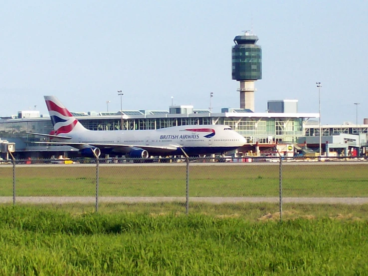 an airplane is on the tarmac near the airport