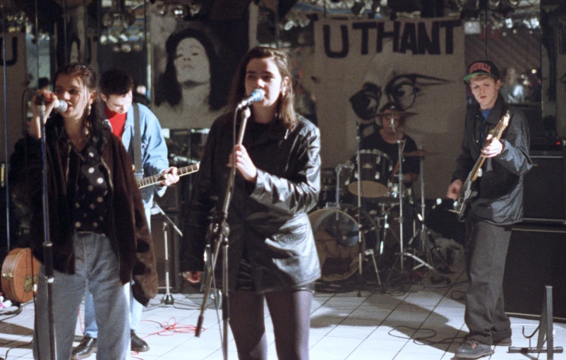 a young band performing on stage with guitars