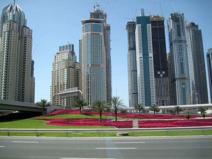 some tall buildings and grass on the ground