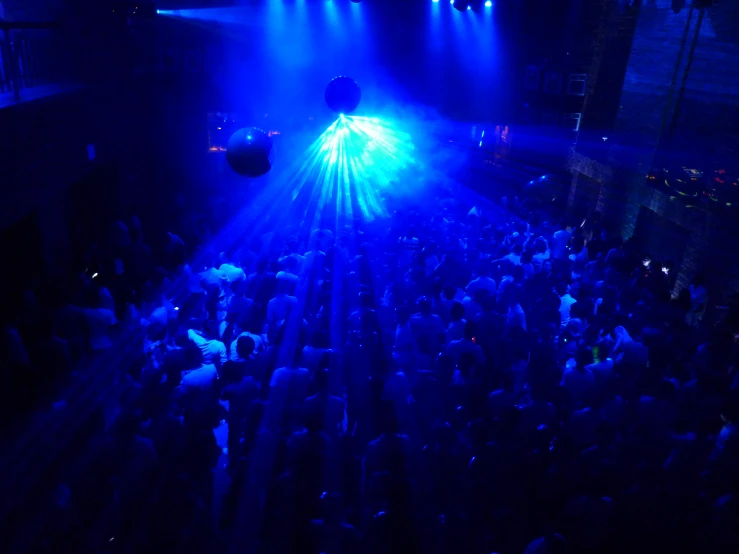 people are watching a large concert in a building