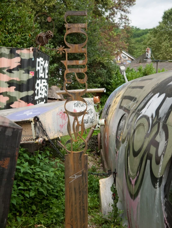 graffiti on the side of two old rusted cars