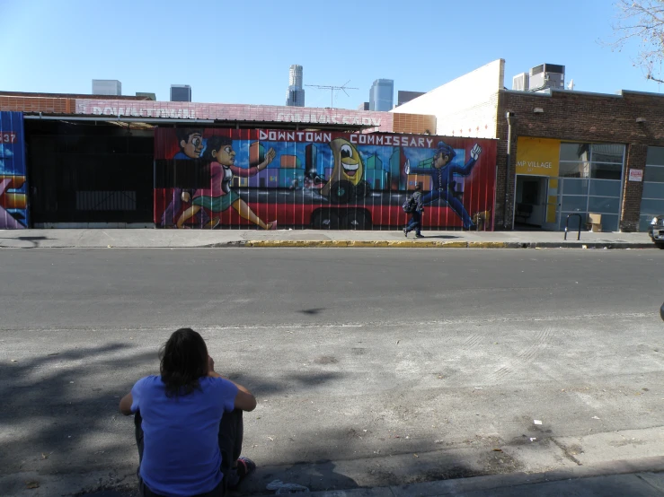 woman sitting in the middle of a street