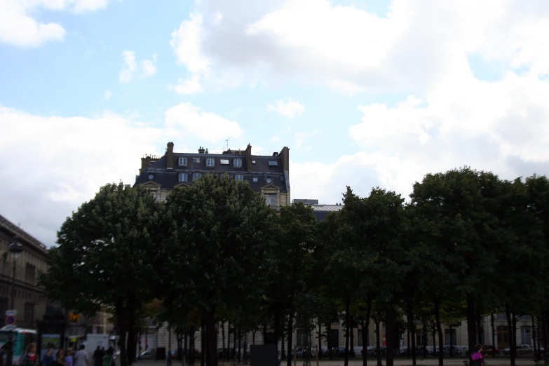 a very tall building with several windows next to trees