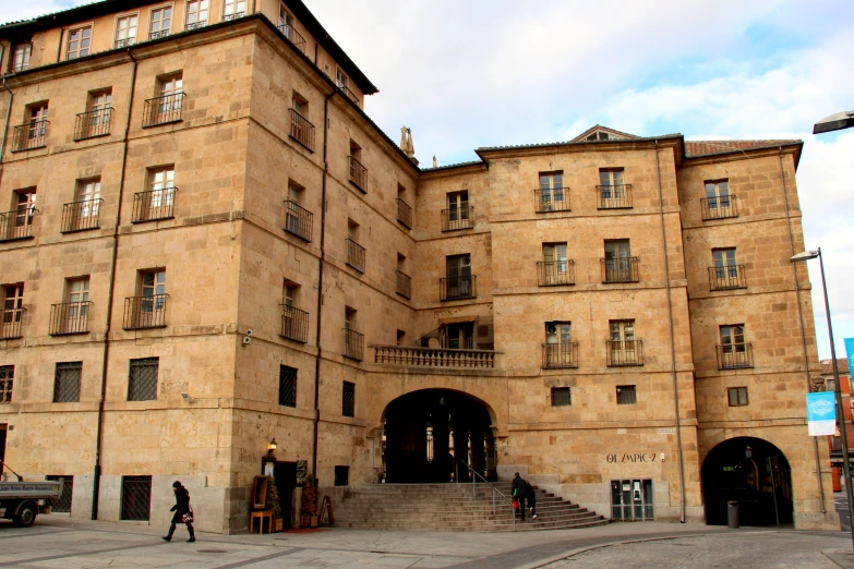 two people walking up and down the stairs to a building