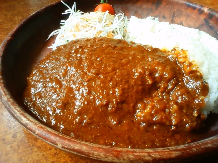 a large brown bowl filled with food on top of a table