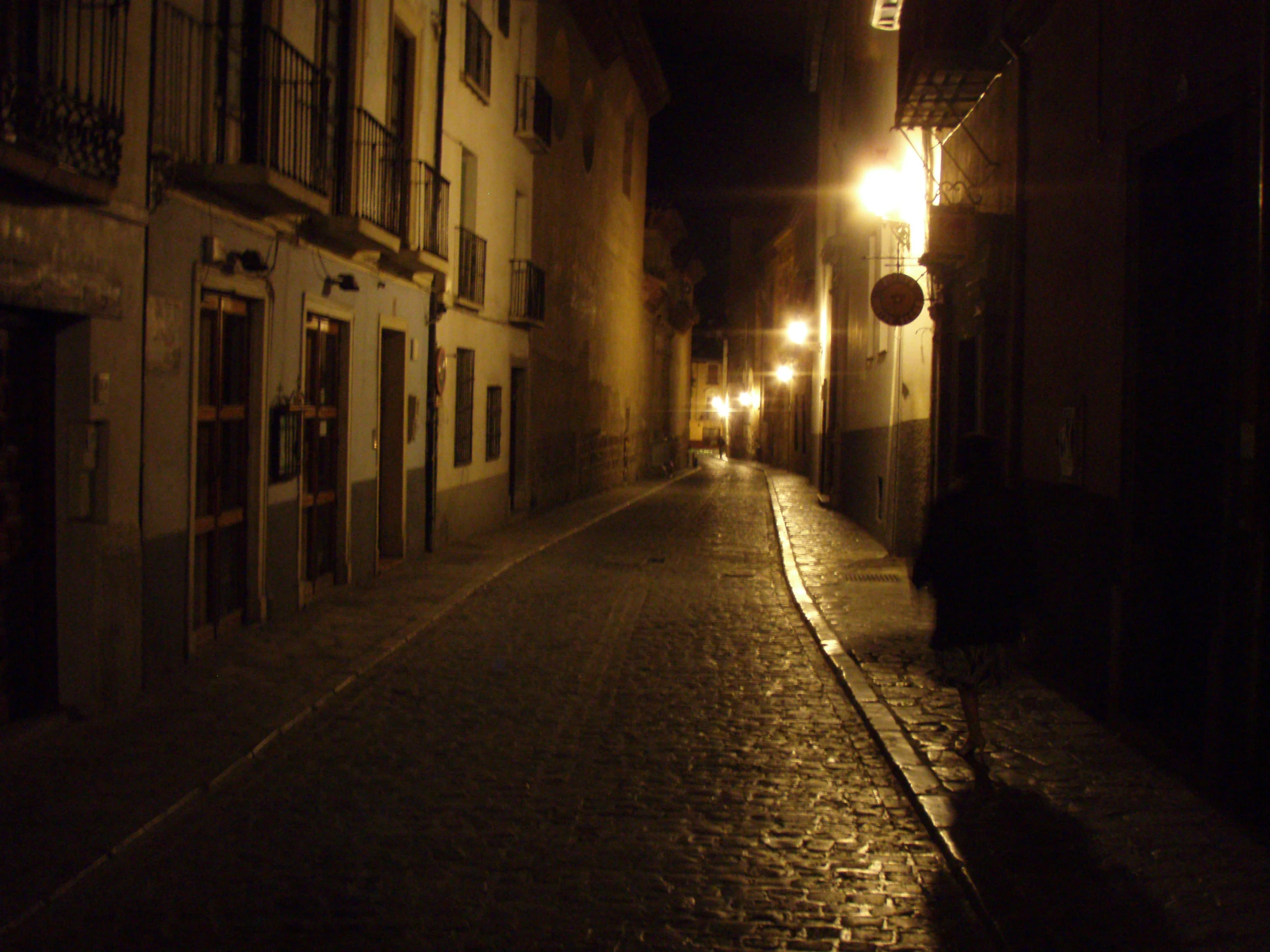 a brick street with a lamp on next to it