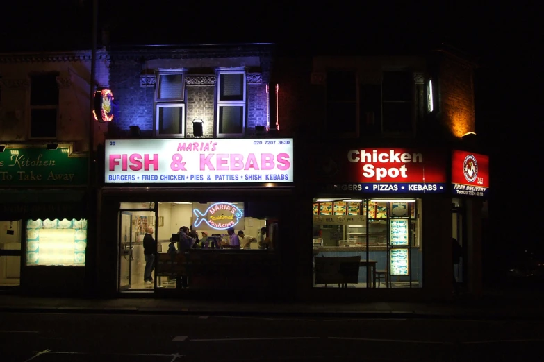 store fronts lit up on a dark street