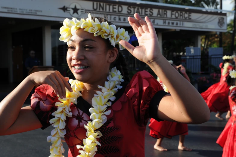 woman wearing leis in front of the united states air force