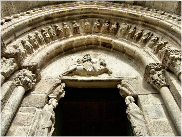 a stone door with ornate carvings in a gothic building