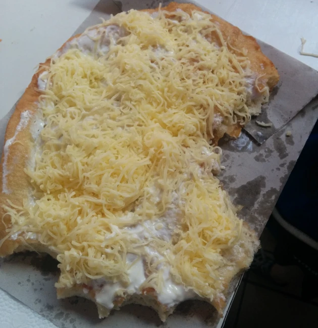 the pizza has cheese on it, but not half covered