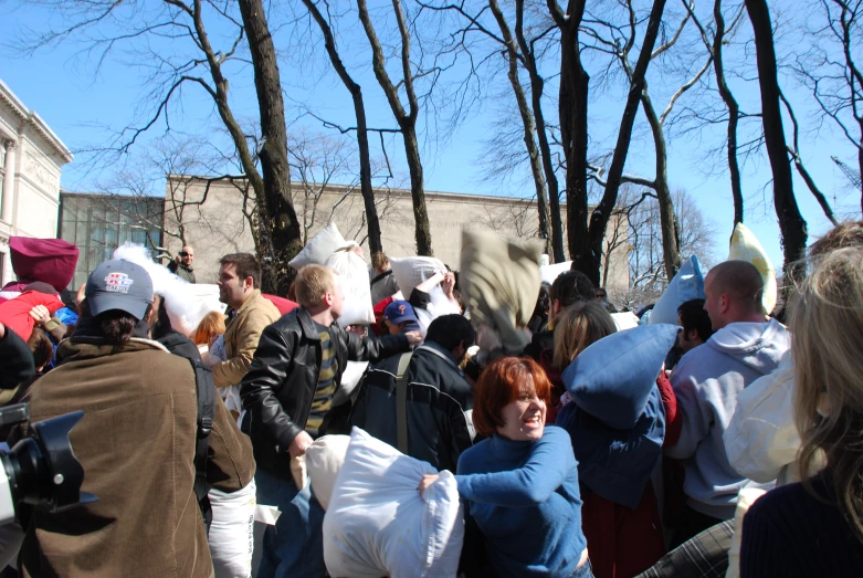crowd of people with several people holding white bags