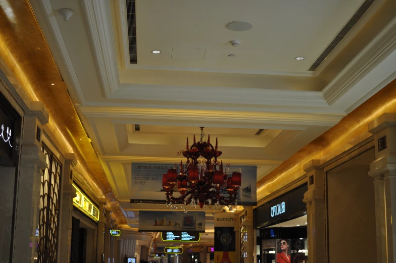 a store with white walls and ceilings has a chandelier