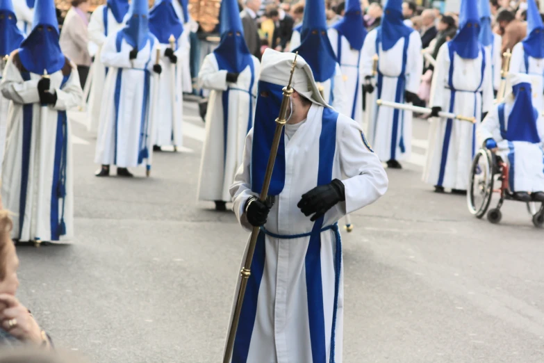 people dressed in blue and white on a street