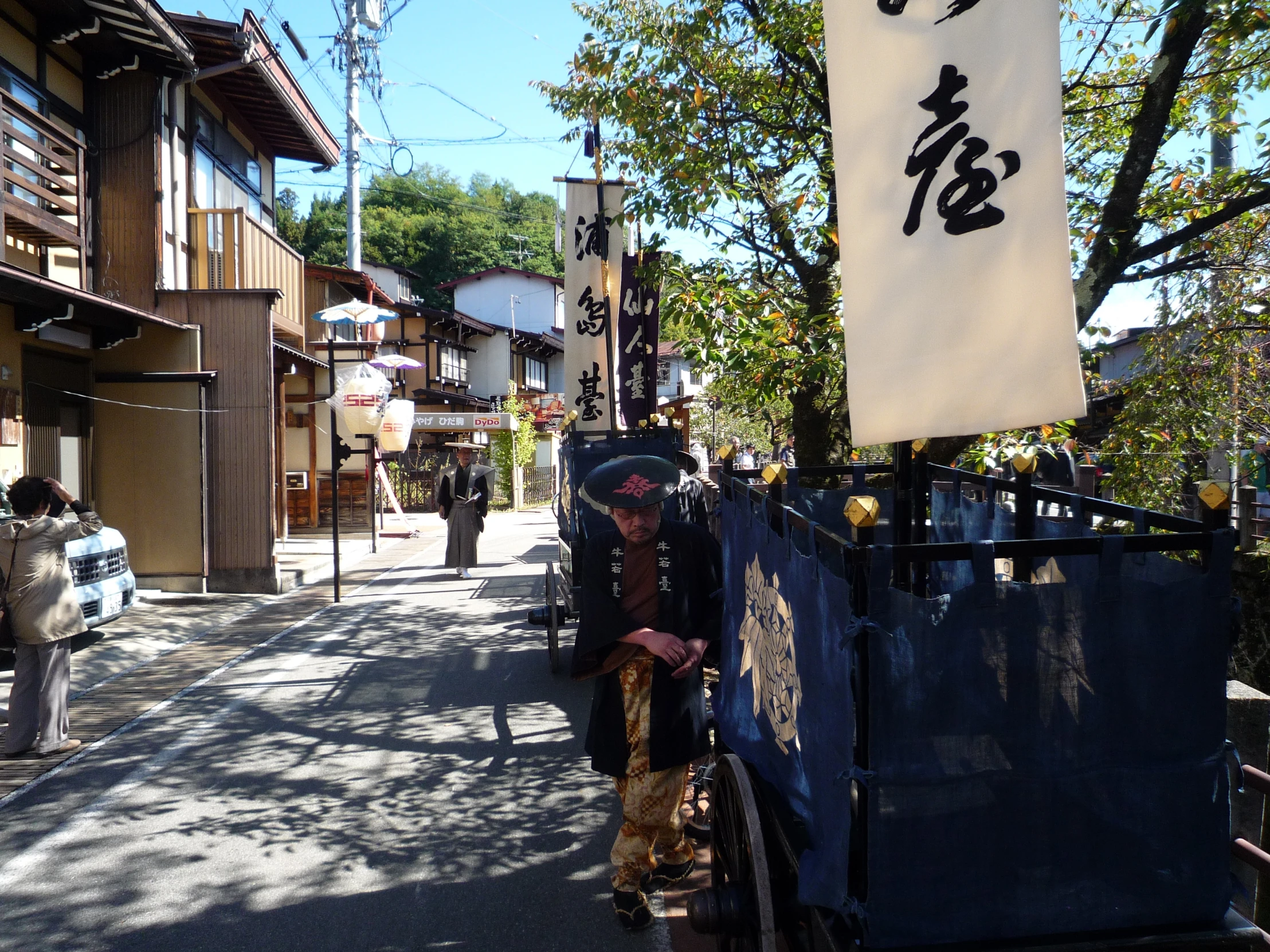 a woman hing a cart down a street